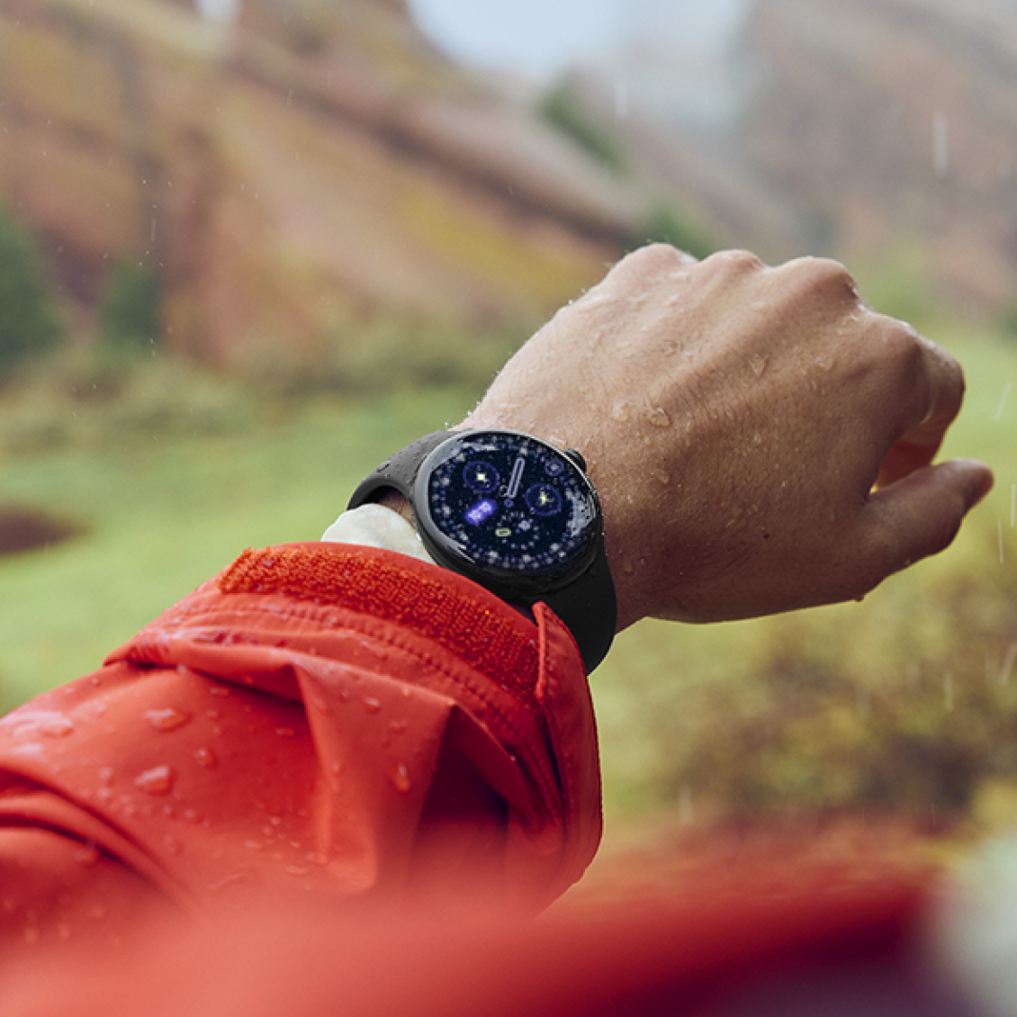 Person wearing Google Pixel Watch outdoors in red jacket